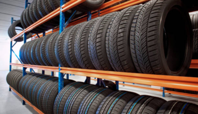 warehouse storing car tyres in rows for sale