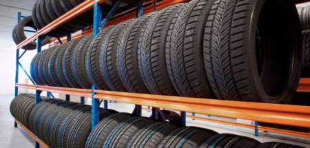 warehouse storing car tyres in rows for sale